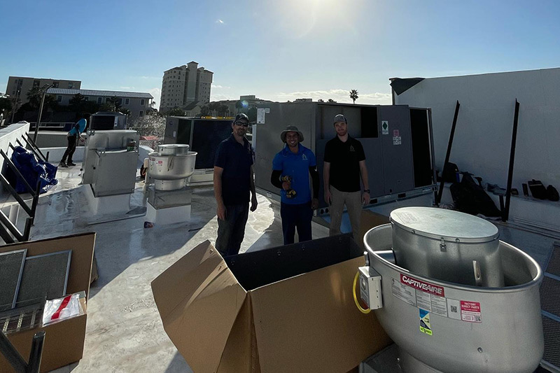 A&G Air Conditioning team standing on roof during commercial HVAC installation in Orlando, Florida