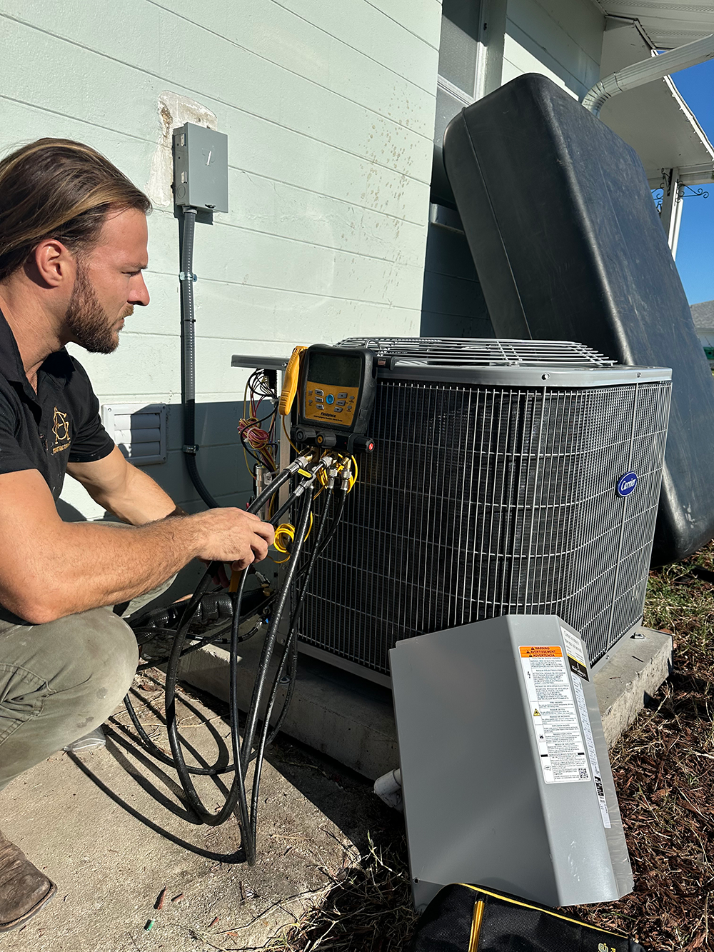 Jimmy, owner of A&G Air Conditioning in Orlando, FL, inspecting a local air conditioning system
