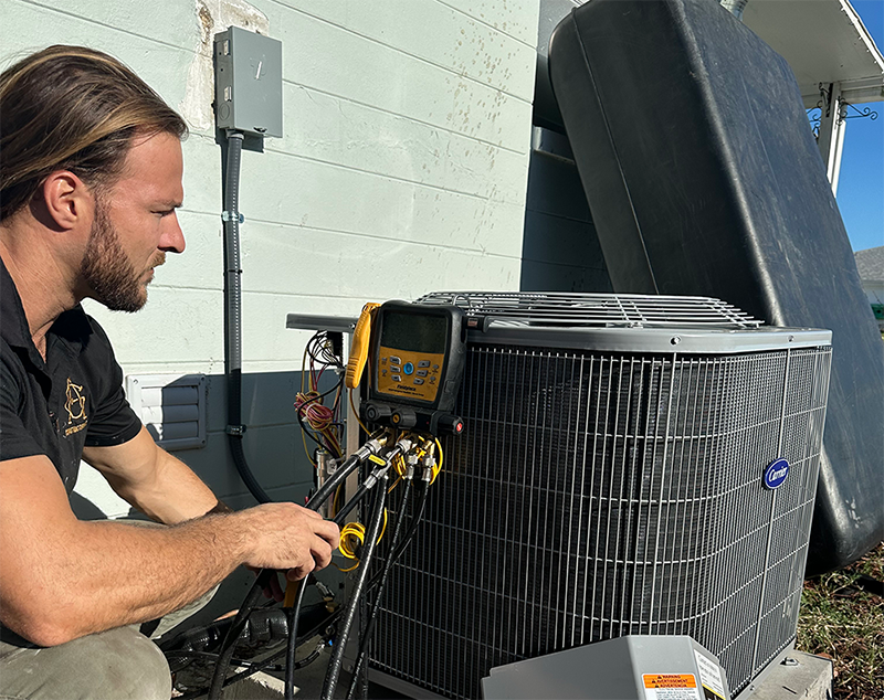 Jimmy, owner of A&G Air Conditioning in Orlando, FL performing an HVAC repair on a residential air conditioning unit